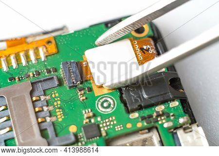 Technician Or Master Repairs A Mobile Phone, He Disconnects The Cable, Snaps Off The Connector And R