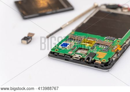 Repair The Mobile Phone On The White Table Copy Space.