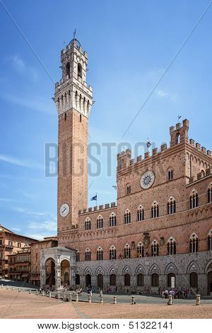 Low angle view of the bell tower of the Palazzo Pubblico, at the Piazzo del Campo, Siena, Italy. 