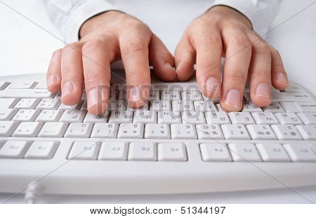Man Typing On A Computer Keyboard