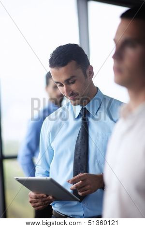 close-up of human hand  business man using tablet compuer at office