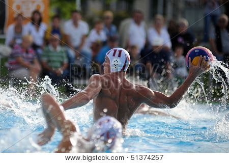 KAPOSVAR, HUNGARY - SEPTEMBER 15: Norbert Juhasz-Szelei (11) in action at a Hungarian championship water-polo game between Kaposvar (white) and Honved (blue) on September 15, 2013 in Kaposvar, Hungary