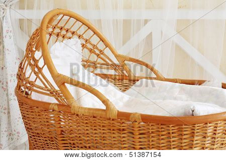 Big beautiful basket with laundry for a small child in light studio.