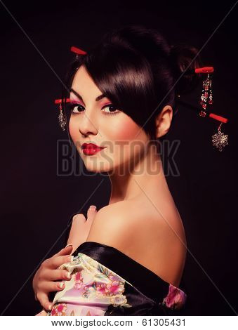Beautiful young woman in red Asian costume