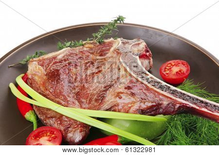 meat food : grilled beef spare rib on dark dish with thyme pepper and tomato isolated over white background