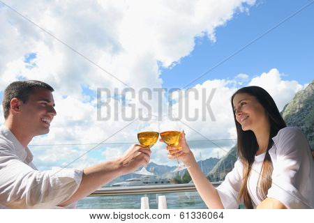 happy young couple having lanch at beautiful restaurant on the beach