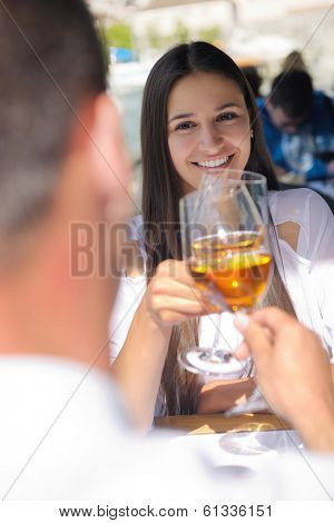 happy young couple having lanch at beautiful restaurant on the beach