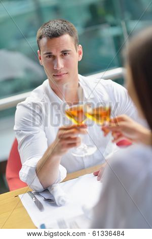 happy young couple having lanch at beautiful restaurant on the beach