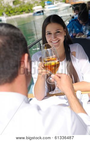 happy young couple having lanch at beautiful restaurant on the beach