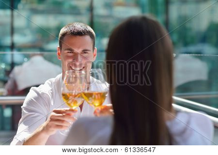 happy young couple having lanch at beautiful restaurant on the beach
