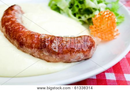 Grilled sausage served with  mash potatoes