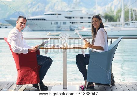 happy young couple having lanch at beautiful restaurant on the beach