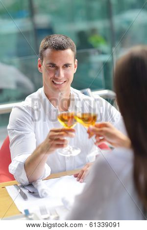 happy young couple having lanch at beautiful restaurant on the beach