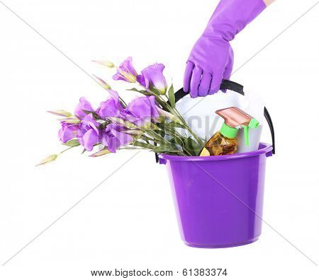 Housewife holding bucket with cleaning equipment. Conceptual photo of spring cleaning. Isolated on white