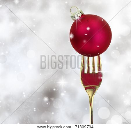 Golden fork with Christmas ball in a glittery background