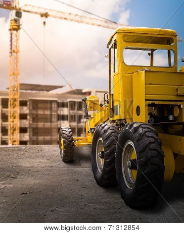 Old Yellow Motor Grader On The Road