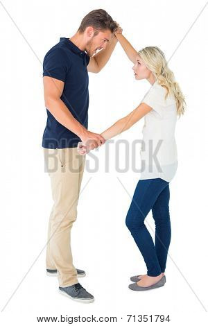Angry man overpowering his girlfriend on white background