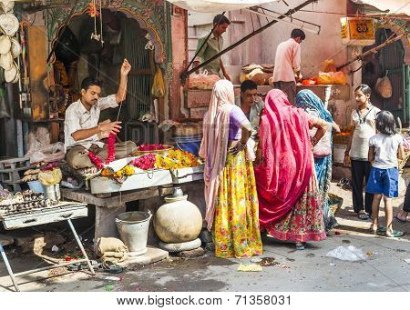 Women Buy Colorful Garlands At The Street Market