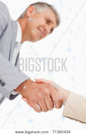 Low angleshot of a hand shake against night sky