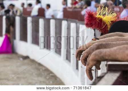 Detail Of The Arms And Hands Of Men Supported In The Barrier Of Bullring