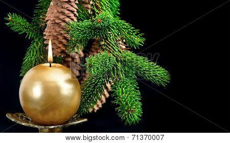 Christmas Tree Branch With Golden Burning Candle