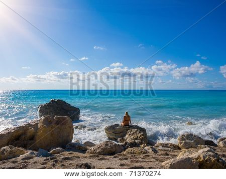 Woman looking at the beach in Kathisma Lefkada Greece