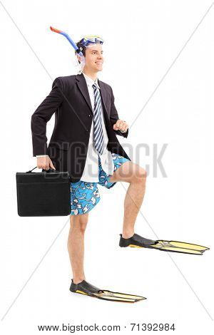 Full length portrait of a businessman walking with scuba fins isolated on white background