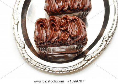 Close Up Of A Chocolate Frosted Brownie On A Siver Tray