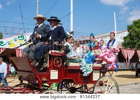 Spanish family in a horse drawn carriage.