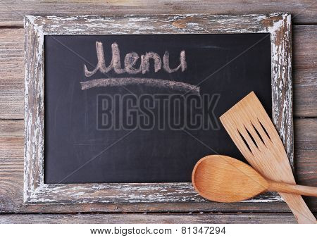 Blackboard menu on rustic wooden planks background