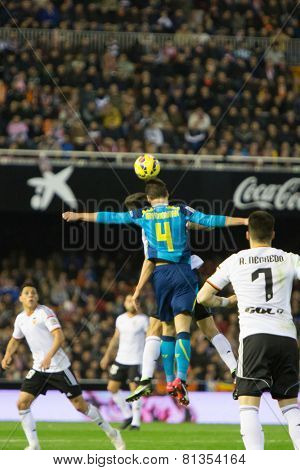 VALENCIA, SPAIN - JANUARY 25: Krychowiak (F) jumping for the ball during Spanish League match between Valencia CF and Sevilla FC at Mestalla Stadium on January 25, 2015 in Valencia, Spain
