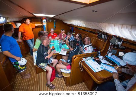 HYDRA, GREECE - CIRCA OCT, 2014: Unidentified sailors on skipper's briefing in the yacht wardroom during sailing regatta 12th Ellada Autumn 2014 among Greek island.