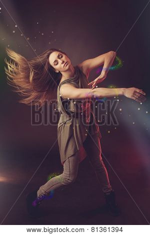 Beautiful Woman Dancer Dancing Over Dark Background With Light Rays And Star Swirls