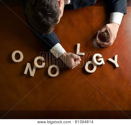Word Oncology and devastated man composition