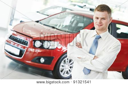 Portrait og salesperson or manager of car automobile dealer welcoming with open arms