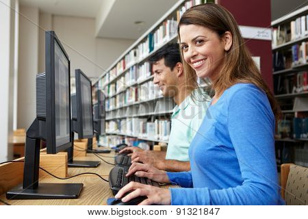 Students working on computers in library