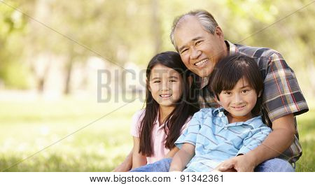 Portrait Asian grandfather and grandchildren in park