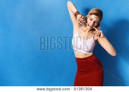 Beautiful sexy blonde woman with make up  in red skirt on blue background