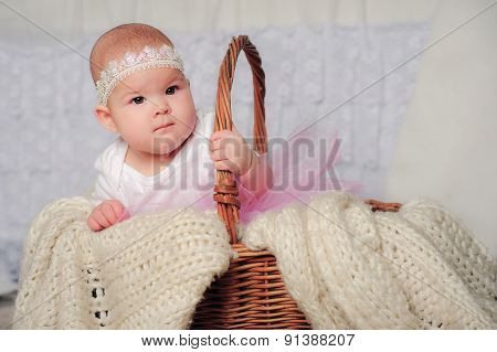 cute little girl in basket with lace headband
