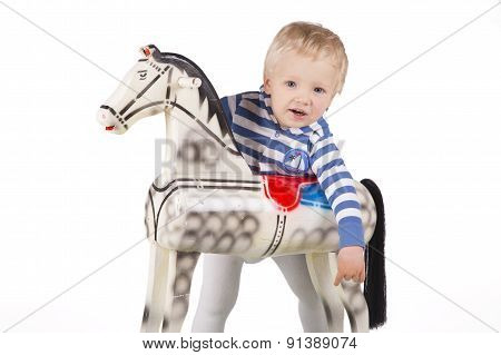 Boy And Wooden Rocking Horse