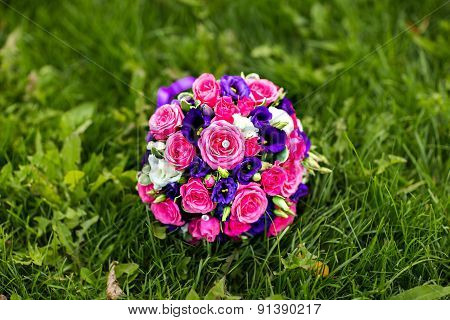 Bride Holding Wedding Bouquet with beautiful Flowers