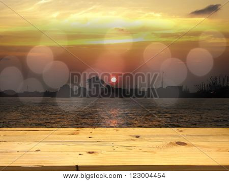 Wood for placing the product on the bokeh sunset in the sea background.