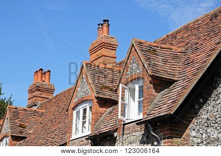 Pretty brick and flint cottages with dormer windows along a village street Hambledon Oxfordshire England UK Western Europe.