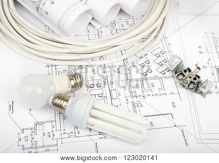 Architecture plan and rolls of blueprints with cabel and bulbs. Building concept