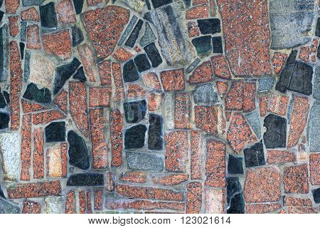 granite wall with brwon, black and orange stones for background