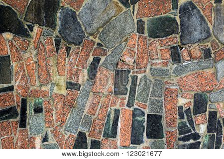 granite wall with brwon, black and orange stones for background