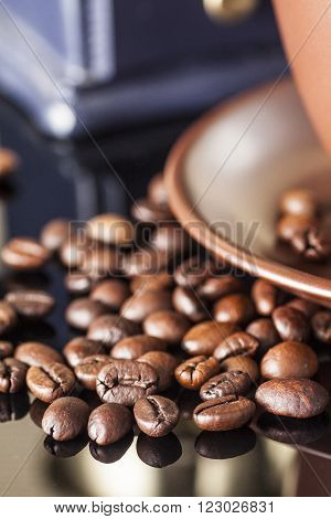 still life with coffee beans and coffee mill on the wooden background
