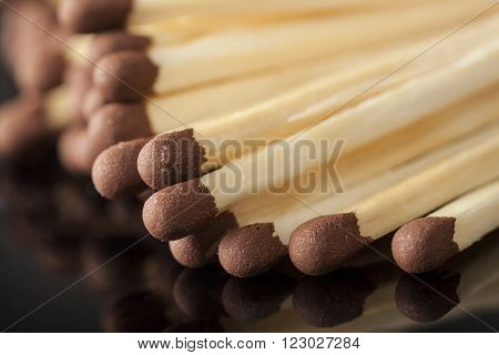white matchbox with matches on a black background