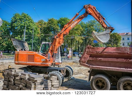 Lviv Ukraine - August 19 2015: Excavator loader machine works at ancient historical center of Lviv