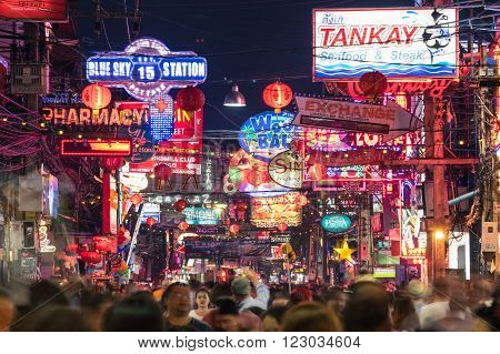 PATTAYA THAILAND - FEBRUARY 18 2016: multicolored neon signs and blurred people on the new Walking Street of the city - The road is closed to the traffic after 6pm and stays crowded until late night